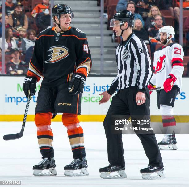 Hampus Lindholm of the Anaheim Ducks protests as he is mistakenly escorted to the penalty box by linesman Travis Gawryletz during the first period of...