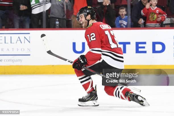 Alex DeBrincat of the Chicago Blackhawks reacts after scoring against the St. Louis Blues in the third period for a hat-trick at the United Center on...