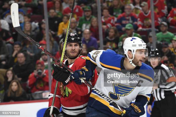 Brandon Saad of the Chicago Blackhawks and Alex Pietrangelo of the St. Louis Blues get physical in the third period at the United Center on March 18,...