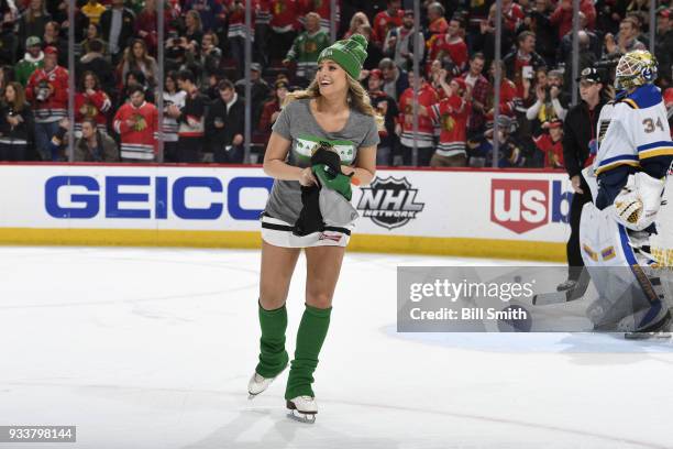 The Chicago Blackhawks ice-crew picks up hats after Alex DeBrincat of the Chicago Blackhawks scored a hat-trick against the St. Louis Blues in the...