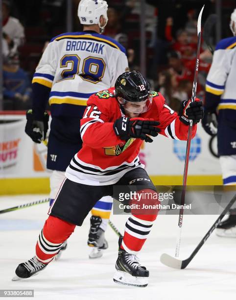 Alex DeBrincat of the Chicago Blackhawks celebrates after scoring his third goal of the game for a hat trick against the St. Louis Blues at the...