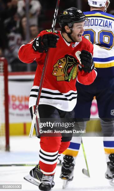 Alex DeBrincat of the Chicago Blackhawks celebrates after scoring his third goal of the game for a hat trick against the St. Louis Blues at the...