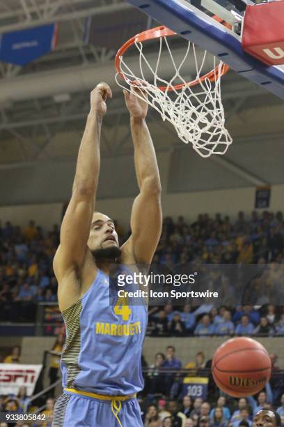 Marquette Golden Eagles forward Theo John finishes a dunk during a National Invitation Tournament game between the Marquette Golden Eagles and the...