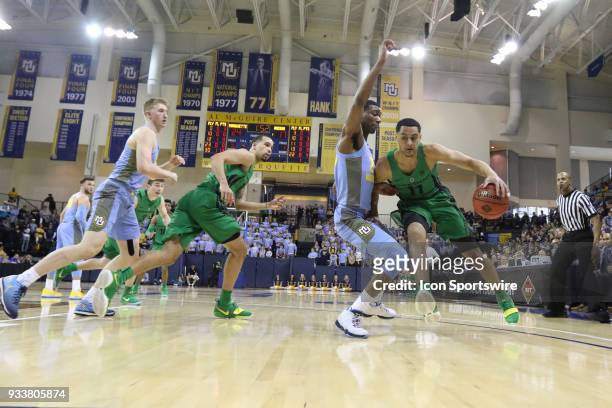 Oregon Ducks forward Keith Smith presses his way with the ball during a National Invitation Tournament game between the Marquette Golden Eagles and...