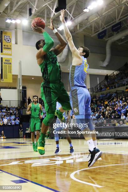 Oregon Ducks forward MiKyle McIntosh shoots during a National Invitation Tournament game between the Marquette Golden Eagles and the Oregon Ducks at...