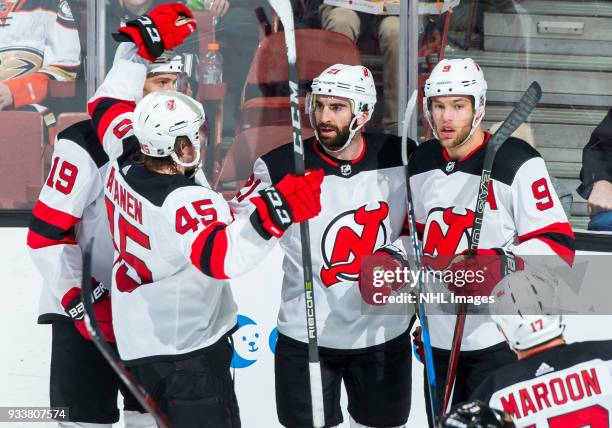 Sami Vatanen of the New Jersey Devils joins Travis Zajac, Kyle Palmieri and Taylor Hall to celebrate Palmieri's second-period goal during the game...