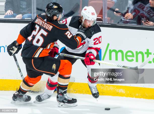 Brandon Montour of the Anaheim Ducks and Blake Coleman of the New Jersey Devils battle for the puck during the second period of the game at Honda...