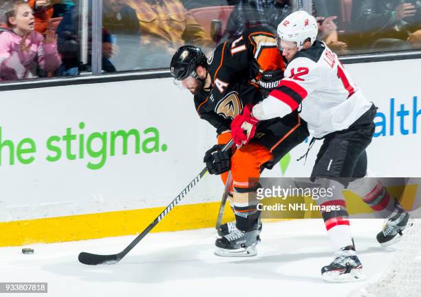 Ryan Kesler of the Anaheim Ducks and Ben Lovejoy of the New Jersey Devils battle for the puck during the second period of the game at Honda Center on...