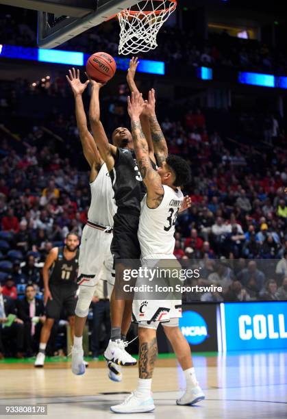 Nevada Wolf Pack guard John Jones splits Cincinnati Bearcats guard Jarron Cumberland and Cincinnati Bearcats forward Gary Clark during the second...