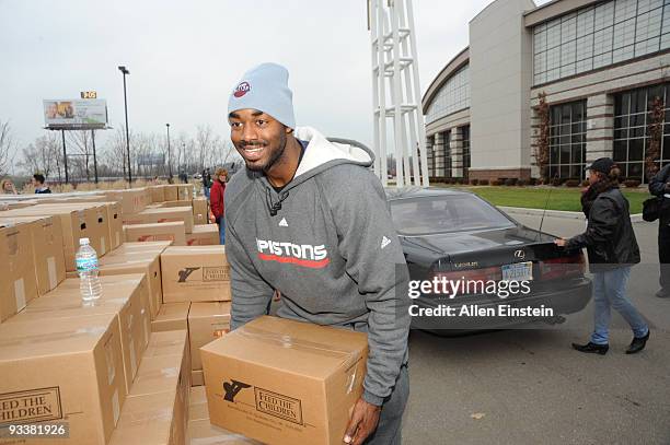 DaJuan Summers of the Detroit Pistons, lifts boxes of food and personal care items as part of the NBA Cares Season of Giving to over 2000 families...