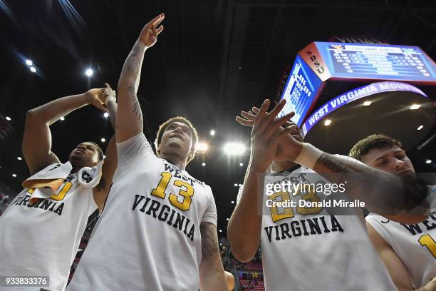 Teddy Allen and Esa Ahmad of the West Virginia Mountaineers celebrate their 94-71 win over the Marshall Thundering Herd during the second round of...