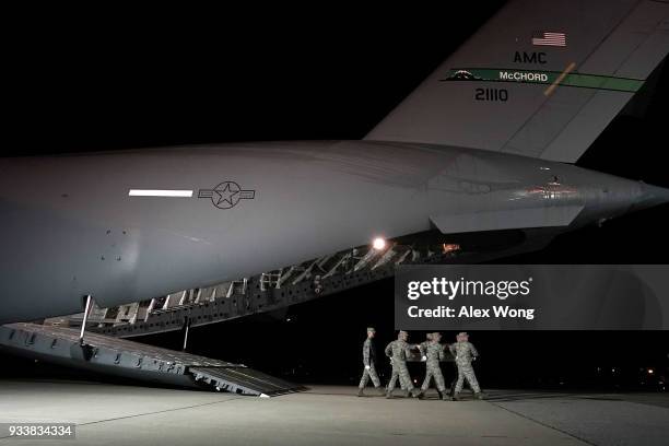Members of a U.S. Air Force carry team move the flag-draped transfer case holding the remains of Air Force Captain Christopher T. Zanetis of Long...