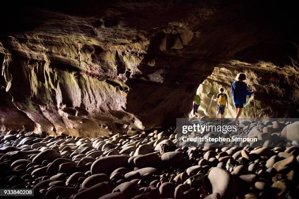 mother and boys exploring coastal cave at low tide - southern california stock pictures, royalty-free photos & images