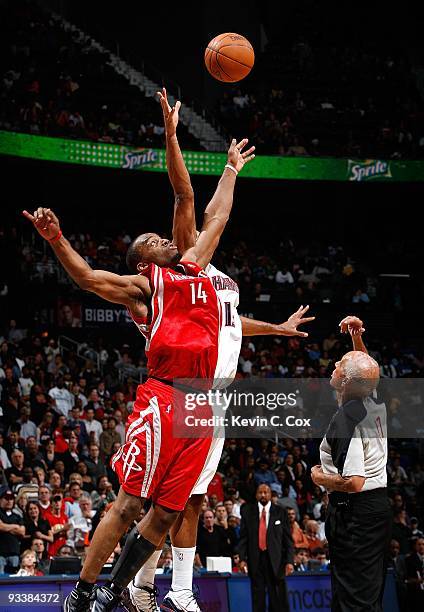 Dick Bavetta tosses the ball for Carl Landry of the Houston Rockets and Al Horford of the Atlanta Hawks at Philips Arena on November 20, 2009 in...