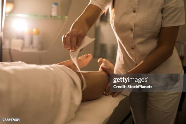 close up women waxing leg - wax strip stock pictures, royalty-free photos & images