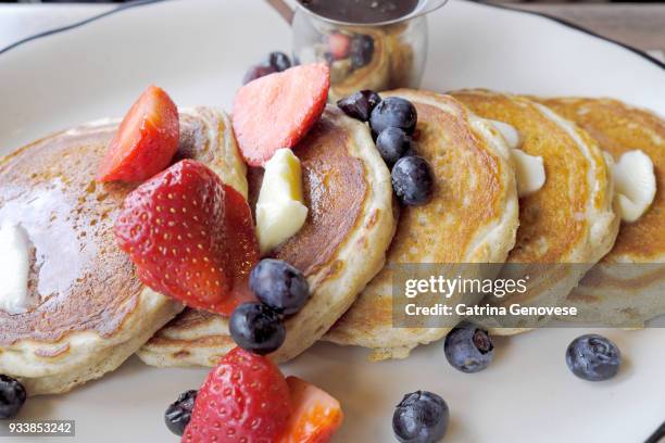 stack of pancakes with fruit and butter at diner - putnam county ストックフォトと画像