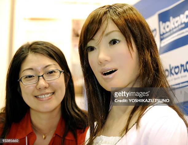 Receptionist robot , produced by Japan's robot maker Kokoro smiles during a demonstration at the International Robot Exhibition in Tokyo on November...