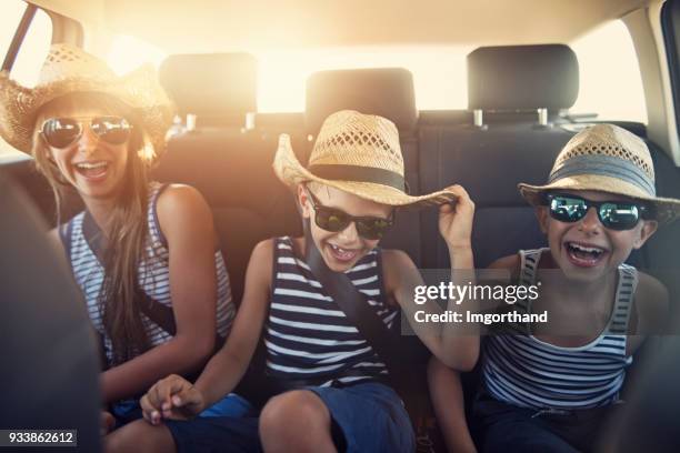 kids enjoying road trip on sunny day - car interior stock pictures, royalty-free photos & images