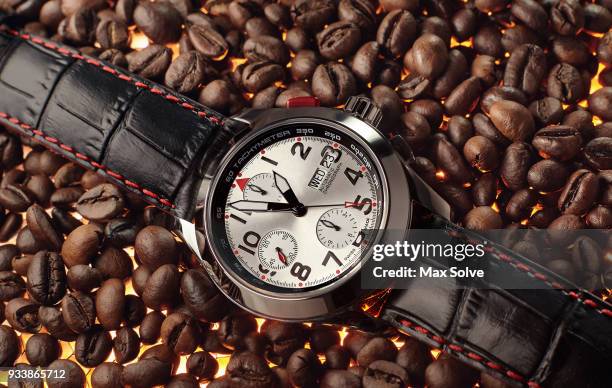 luxury chronograph wristwatch on coffee - chronograaf stockfoto's en -beelden