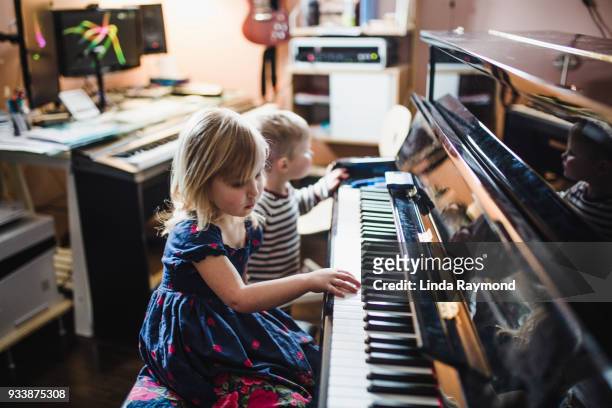 Young children playing piano
