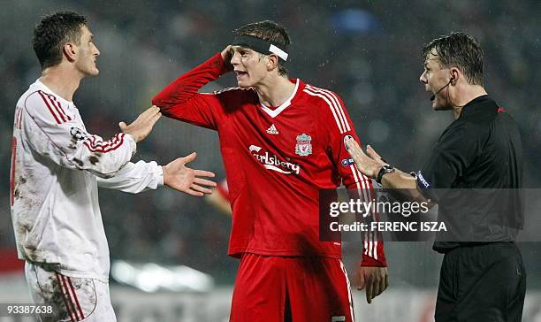 Liverpool's Dutch defender Daiel Agger argues with Debrecen's Swiss-Macedonian defender Mirsad Mijadinoski during the UEFA Champions League match at...