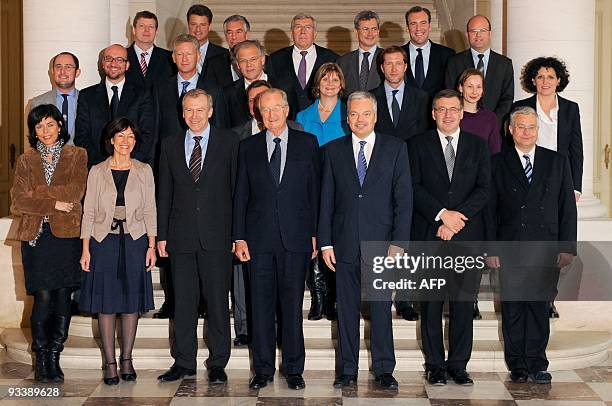 Newly appointed Prime Minister Yves Leterme and King Albert II pose with members of the new government after the oath taking ceremony at the Royal...