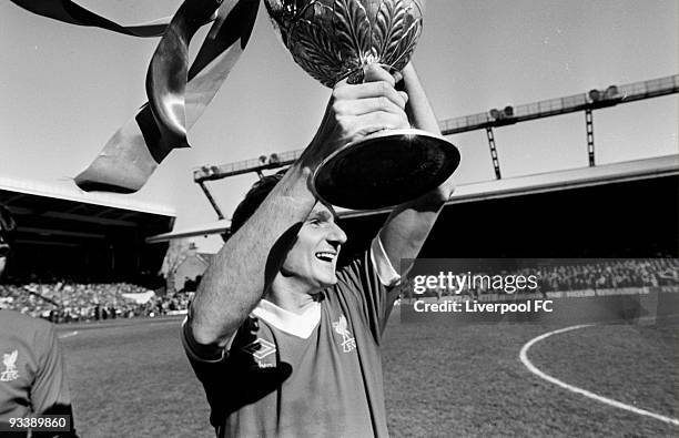 Liverpool captain Phil Thompson holds the Football League Division One trophy after the Football League Division One match between Liverpool and...