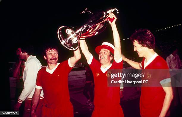 Tommy Smith, Ian Callaghan and Phil Neal of Liverpool parade the trophy after the 1977 European Cup Final between Liverpool and Borussia...