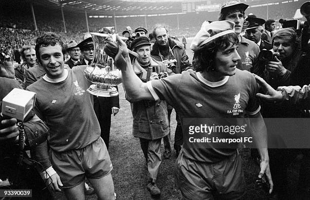 Liverpool players Ian Callaghan and Kevin Keegan parade the winning trophy after the 1974 FA Cup Final between Liverpool and Newcastle United held on...