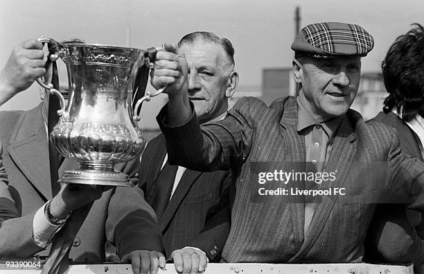 Liverpool manager Bill Shankly in tartan cap holds the winning trophy on the Open Top Bus during the Liverpool FC 1974 FA Cup Victory Parade after...