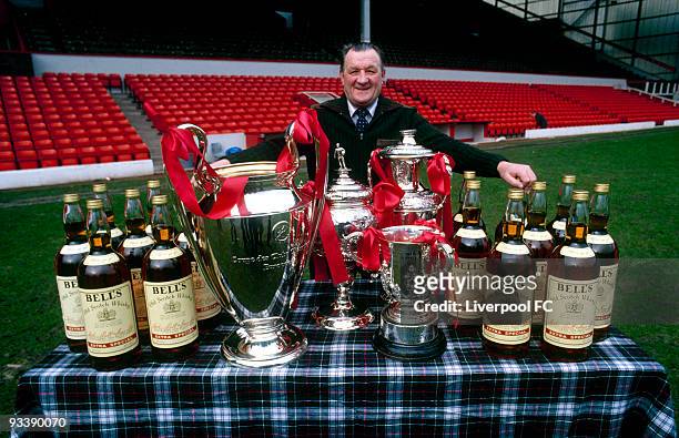 Liverpool manager Bob Paisley stands on the Anfield pitch, proudly displaying his haul from the 1980-81 season which included the European Cup ,...