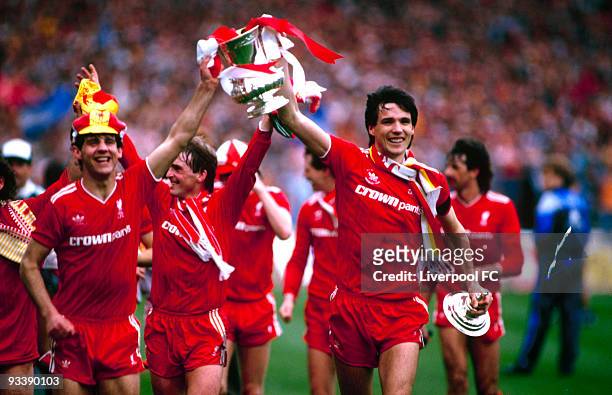 Liverpool players Jim Beglin and Alan Hansen parade the FA Cup trophy after the FA Cup Final between Liverpool and Everton held on May 10, 1986 at...