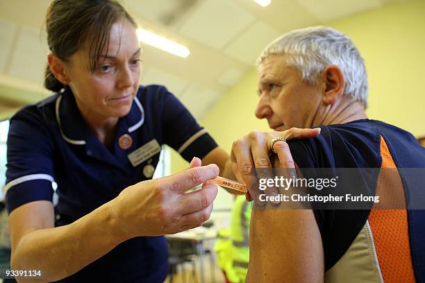 Member of the public is given an innoculation against Swine flu at a medical centre set up in Cockermouth Methodist Church on November 25, 2009 in...