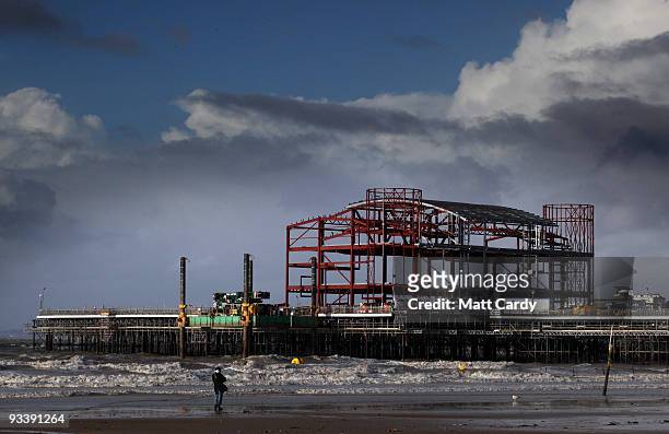 Walker stops to look at the new steel framework of Weston-Super-Mare's Grand Pier on November 25, 2009 in Weston-Super-Mare, England. Although the...