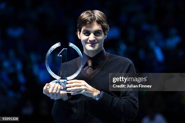 Roger Federer of Switzerland poses with the ATP World Tour Champion Trophy during the Barclays ATP World Tour Finals at the O2 Arena on November 25,...
