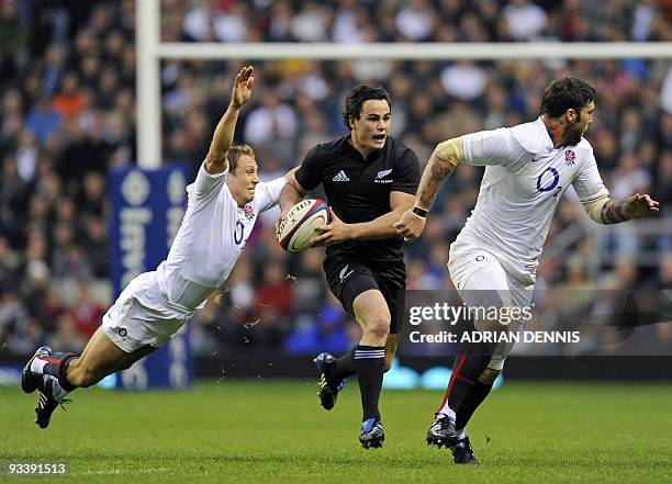 England's Fly Half Jonny Wilkinson dives to tackle and strip the ball from New Zealand's right wing Zac Guildford in front of England wing Matt...