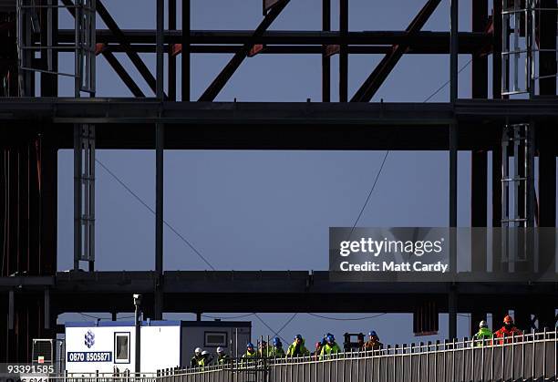 Contractors walk in front of the new steel framework of Weston-Super-Mare's Grand Pier on November 25, 2009 in Weston-Super-Mare, England. Although...