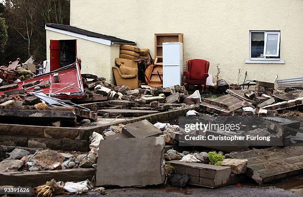 Debris litters the garden of a home in the wake of last weeks devastating floods in Cumbria on November 25, 2009 in Cockermouth, England. An army of...