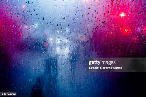 city in the rain seen from a bus - purple bus stock pictures, royalty-free photos & images