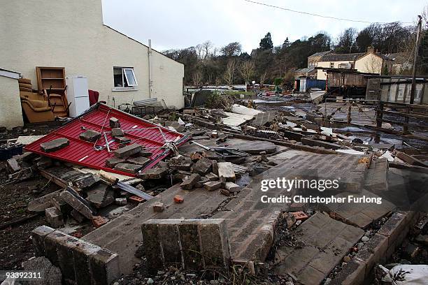 Debris litters the garden of a home in the wake of last weeks devastating floods in Cumbria on November 25, 2009 in Cockermouth, England. An army of...