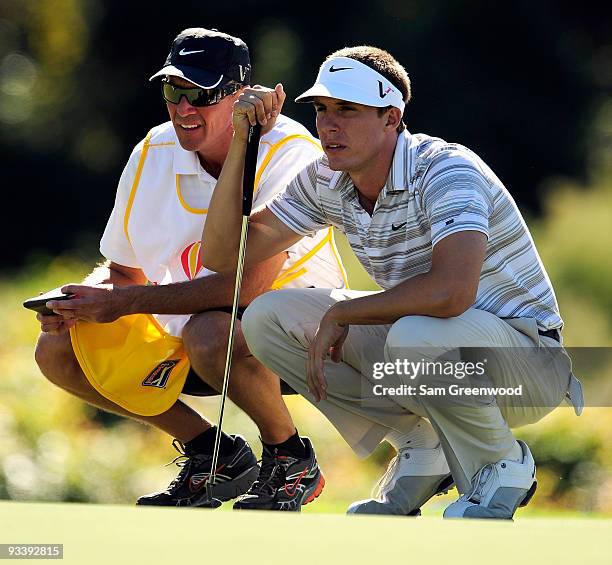 Jamie Lovemark lines up a putt with the help of his caddie on the 16th hole during the second round of the Children's Miracle Network Classic at the...