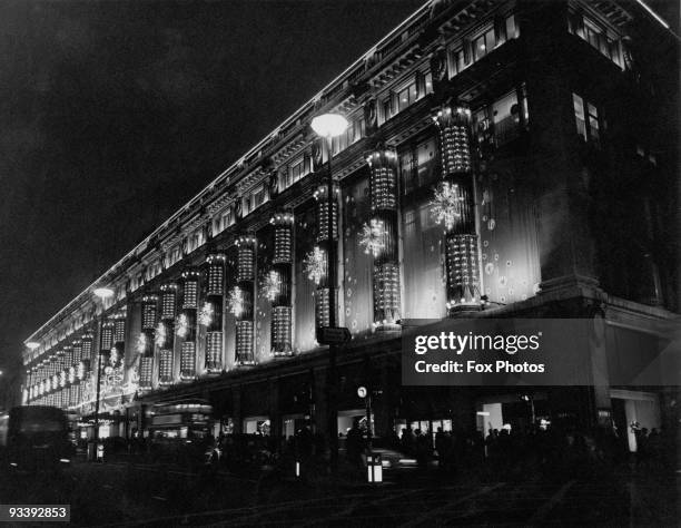 Selfridges department store in Oxford Street, London, decorated with Christmas lights 1968.