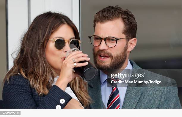 Amelia Warner and Jamie Dornan attend day 4 'Gold Cup Day' of the Cheltenham Festival at Cheltenham Racecourse on March 16, 2018 in Cheltenham,...