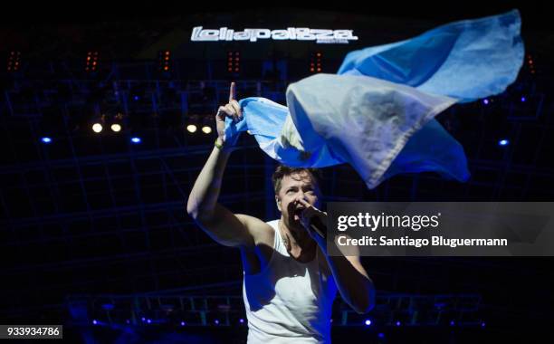 Dan Reynolds of Imagine Dragons waves the flag of Argentina during the first day of Lollapalooza Buenos Aires 2018 at Hipodromo de San Isidro on...