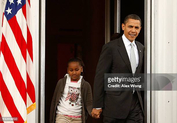 President Barack Obama walks towards the podium with his daughter Sasha during an event to pardon a turkey named "Courage" at the North Portico of...