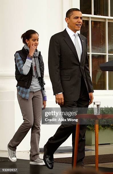 President Barack Obama, followed by his daughter Malia , walks towards the podium during an event to pardon a turkey named "Courage" at the North...