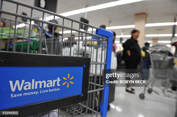 Shoppers wait in line to pay for their p Shoppers wait in line to pay for their p