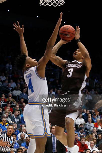 Jaylen Adams of the St. Bonaventure Bonnies attempts to shoo the ball over the defense of Jaylen Hands of the UCLA Bruins during the game at UD Arena...
