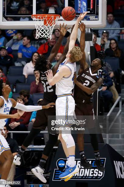 Amadi Ikpeze of the St. Bonaventure Bonnies and Matt Mobley of the St. Bonaventure Bonnies attempt to block the shot of Thomas Welsh of the UCLA...