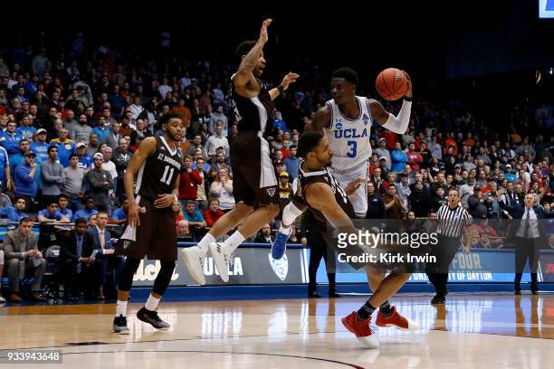 Aaron Holiday of the UCLA Bruins collides with LaDarien Griffin of the St. Bonaventure Bonnies while driving to the hoop during the game at UD Arena...